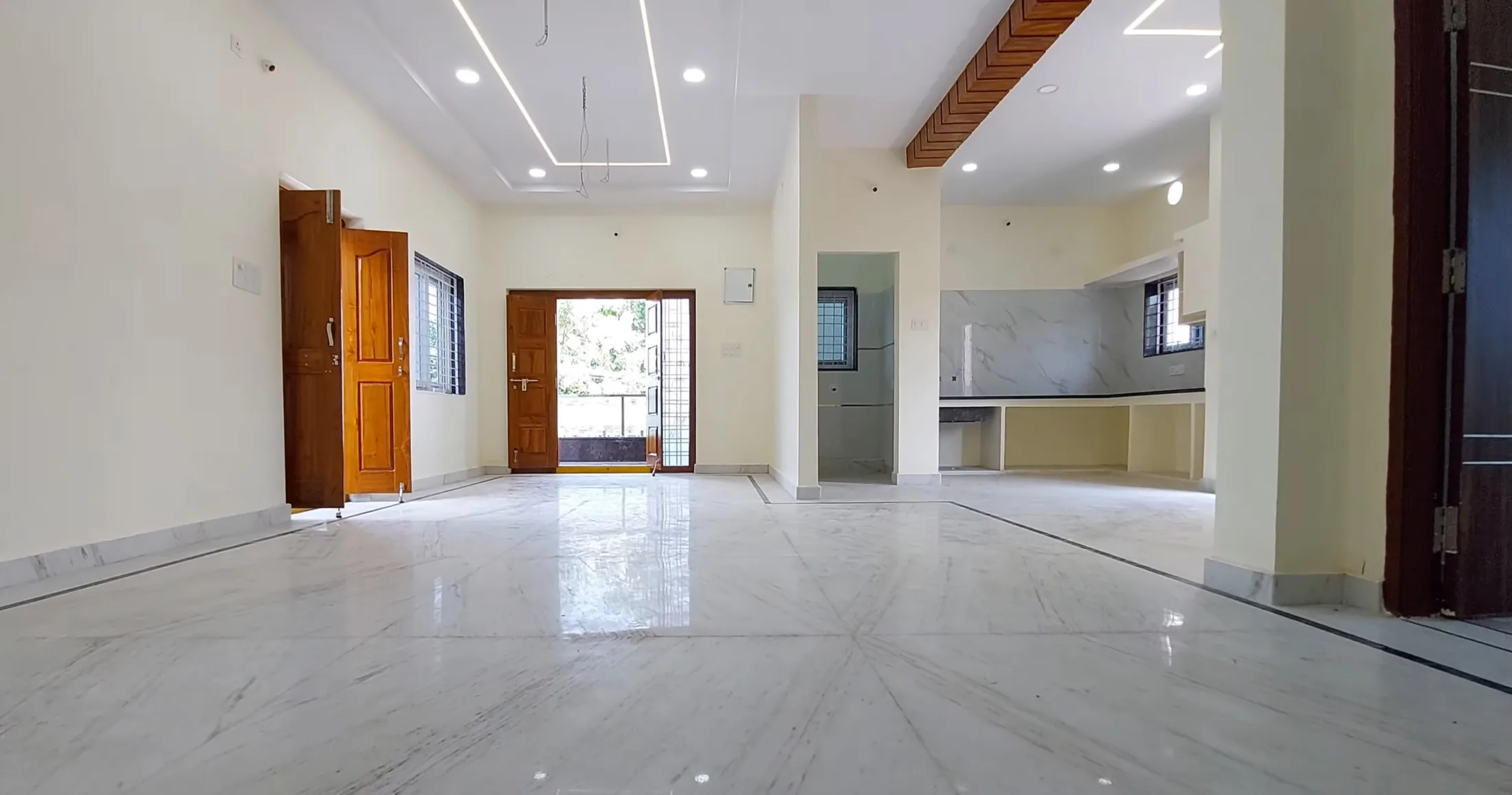 Grand living room before redesign — bare marble floors and unfinished walls